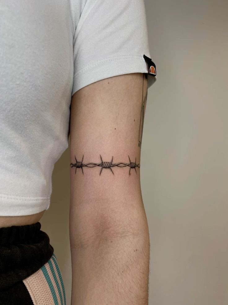 Ostnatý drát kolem paže.