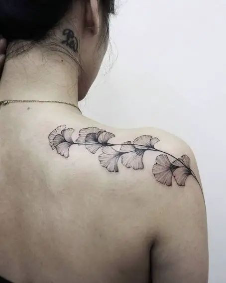 Tetování ginko biloby na rameni.