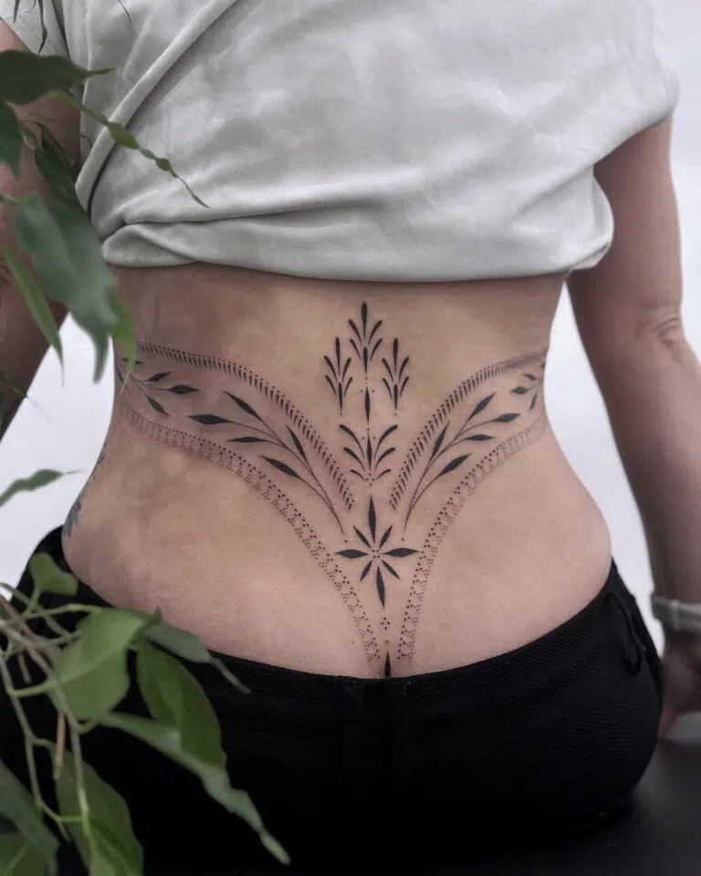 Tetování ornamenty s květinami a tečkami na bedrech